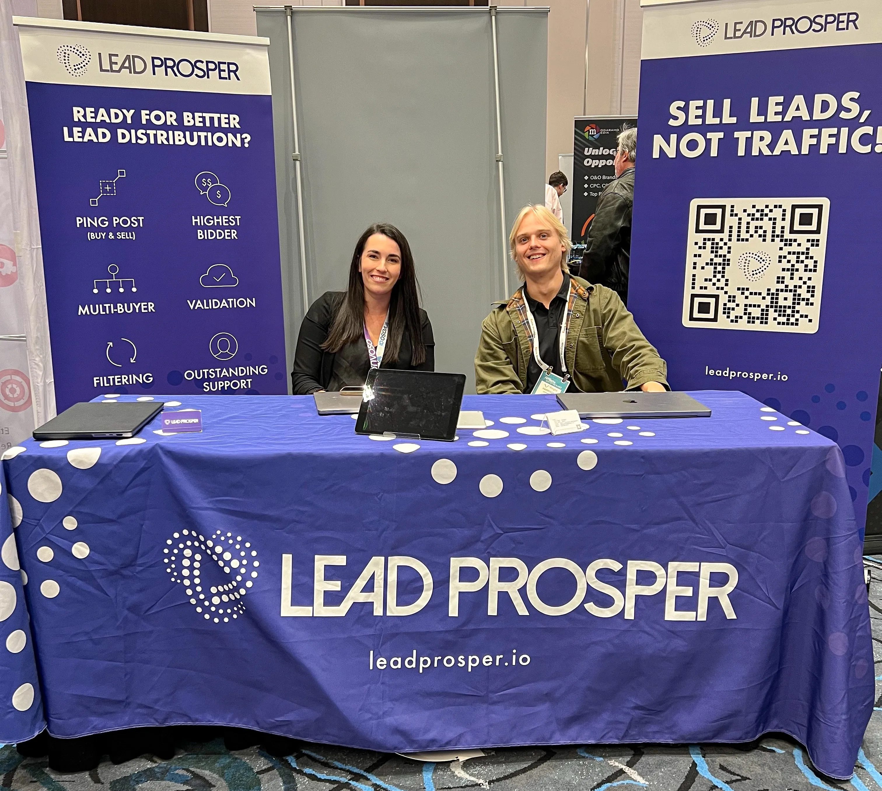 Lead Prosper’s Jackie Akey (left) and Harrison Johnston (right) pose by Table #1345 in Las Vegas, Nevada, during Affiliate Summit West