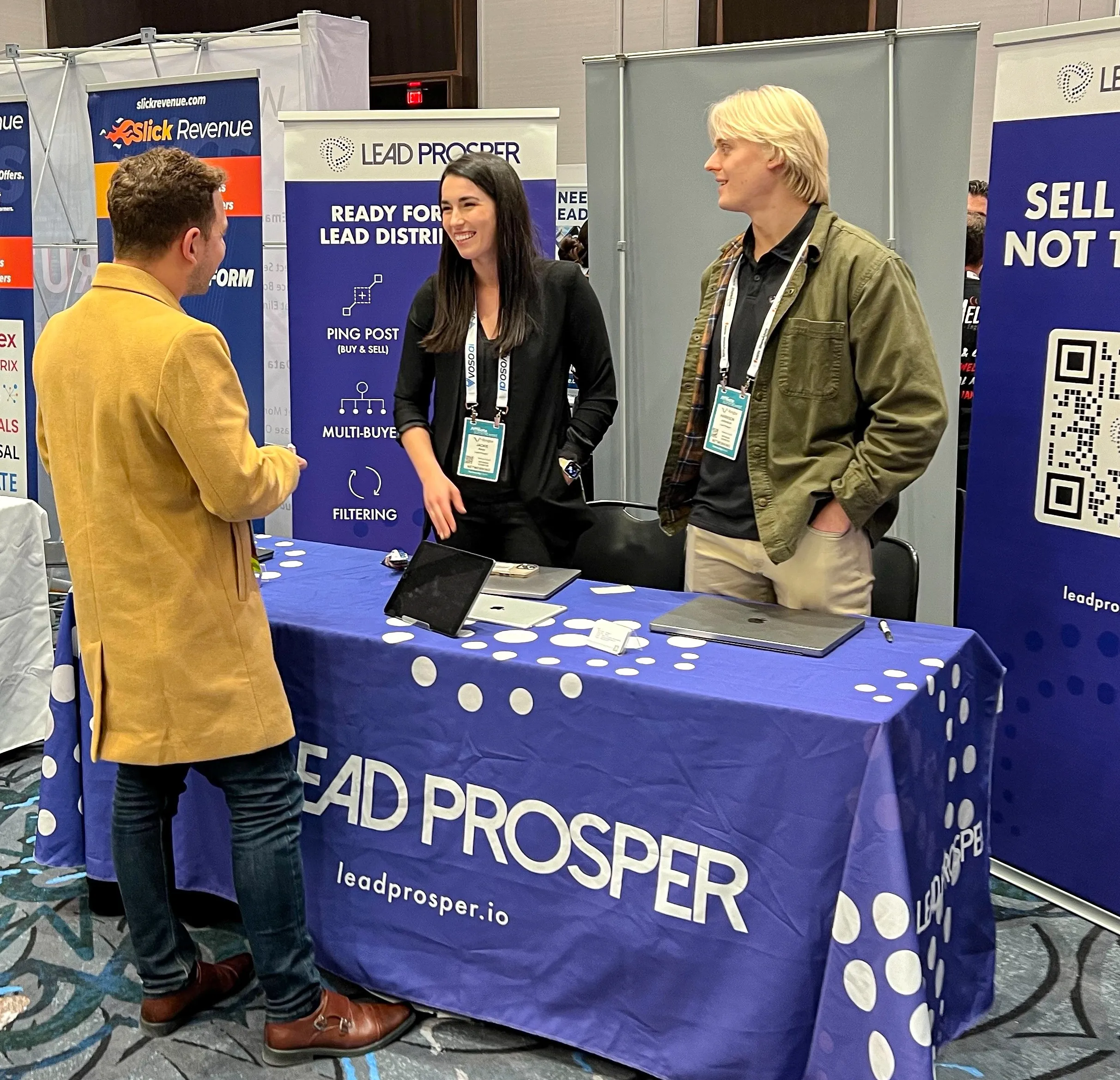 Akey and Johnston converse with an attendee of ASW about Lead Prosper.